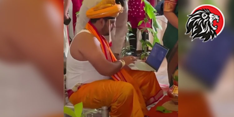 Groom Sits On The Mandap With His Laptop